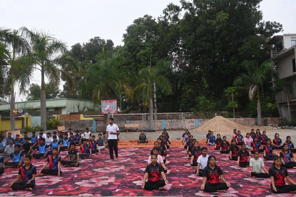 Large group yoga and meditation session at GREMS