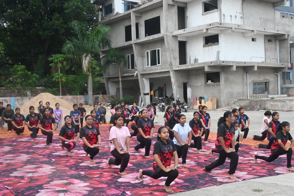GREMS students practicing yoga lunges outdoors